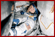 Thomas tries on his Sokol suit onboard the Soyuz